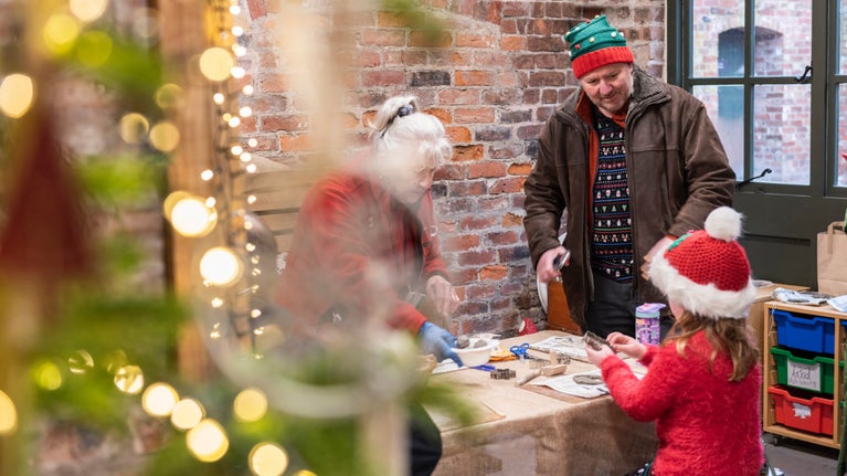 Visitors making Christmas tree decorations at Erddig